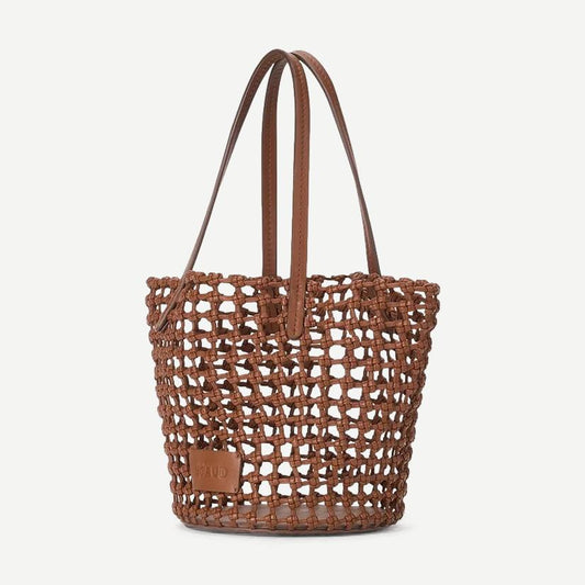 Staud Caro Bucket Bag in tan leather with adjustable strap and minimalist design, shown on a plain background.