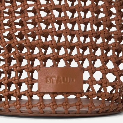 Tan Staud Caro Bucket Bag made of purses material, featuring a rounded shape, stylish handle, and minimalist design.