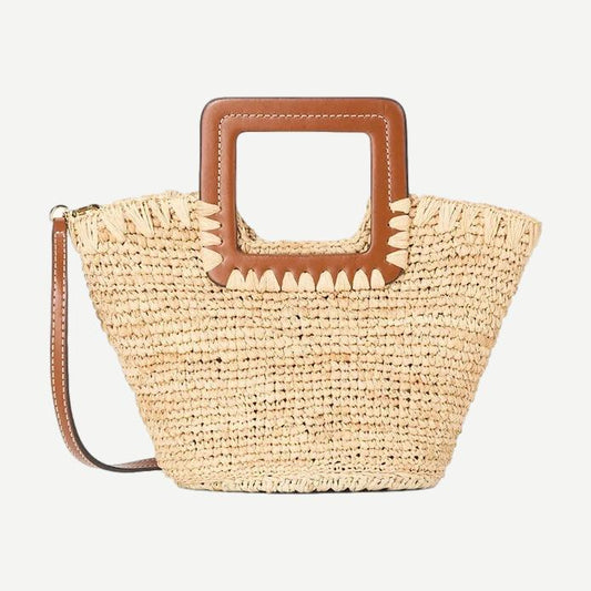 Staud Shirley Raffia Mini Bucket Purse in natural tan with woven raffia texture and short handle, stylish and compact accessory.