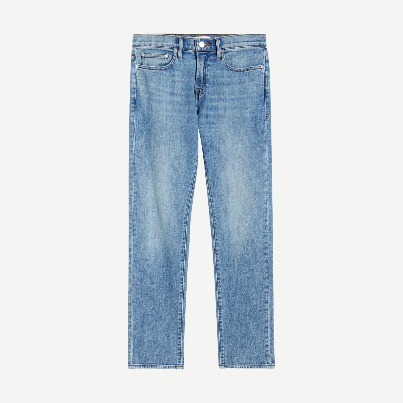 Frame Denim L'Homme Slim Jean in denim, showcasing the slim fit and classic design with detailed stitching and a button fly.