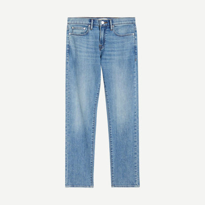 Frame Denim L'Homme Slim Jean in denim, showcasing the slim fit and classic design with detailed stitching and a button fly.