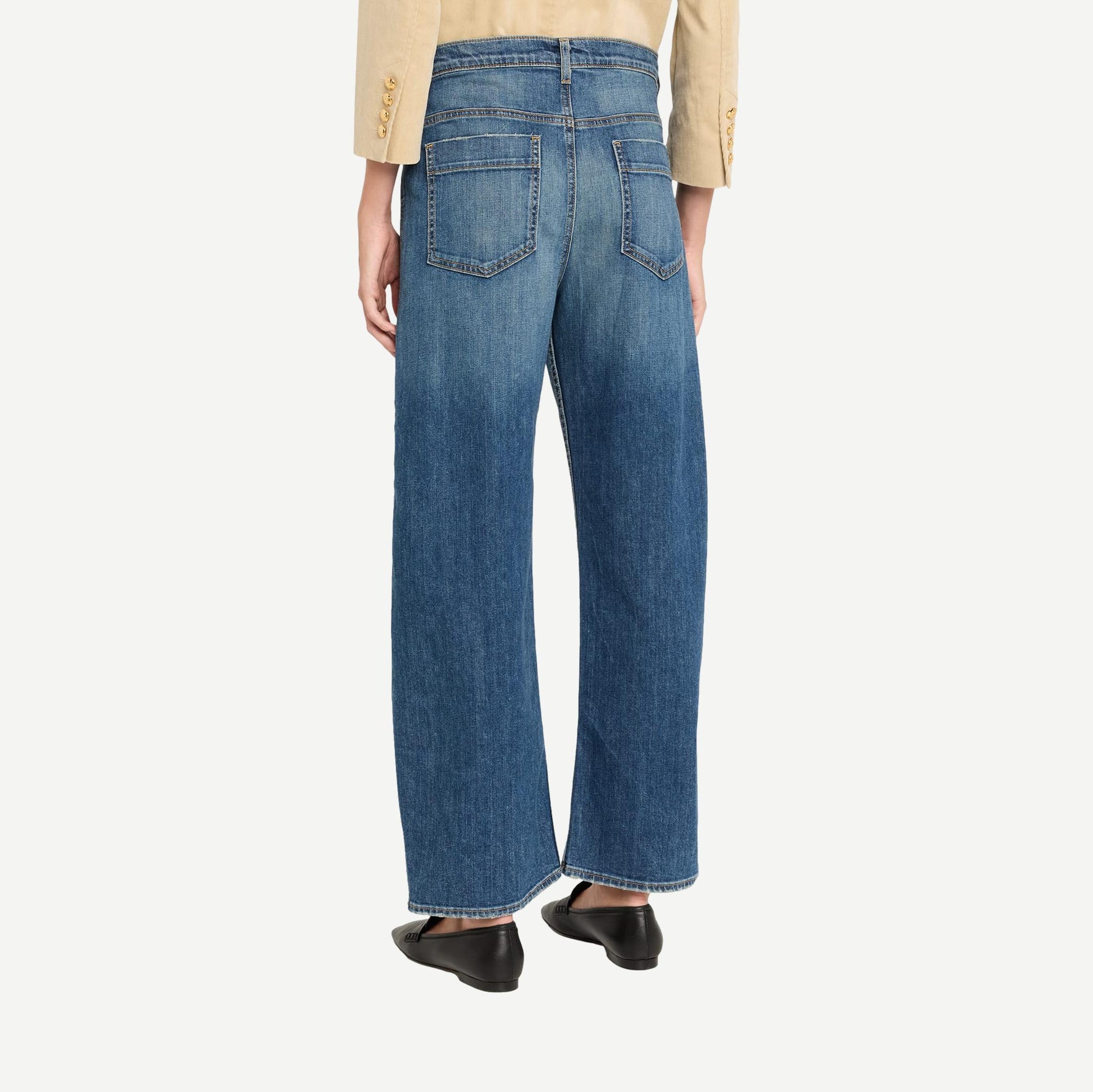 Nili Lotan Tribeca Jean in Classic Wash denim, showing a close-up of the stylish, fitted denim jeans with subtle fading and stitching details.