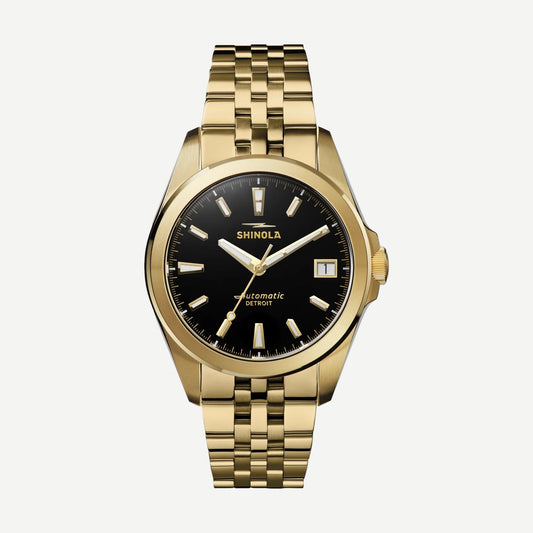 Shinola Circadian Monster Automatic 36mm watch with gold and black dial, stainless steel case, and black leather strap.