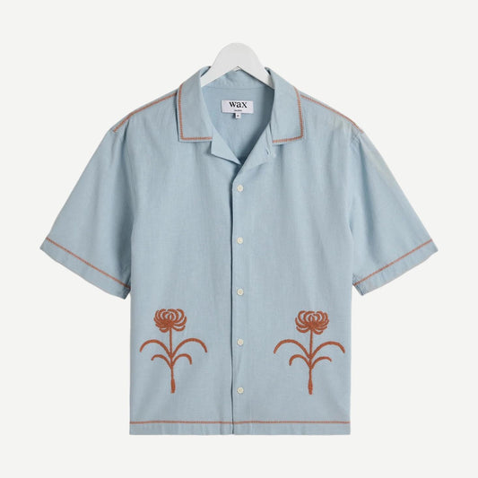 Light blue short-sleeve shirt with rust embroidery from Wax London's Keats SS Shirt Dahlia Embroidery collection.