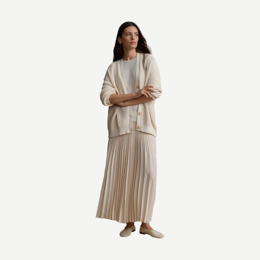Ivory pleated skirt by Jenni Kayne, showcasing flowing fabric and elegant pleats, styled for a sophisticated look.